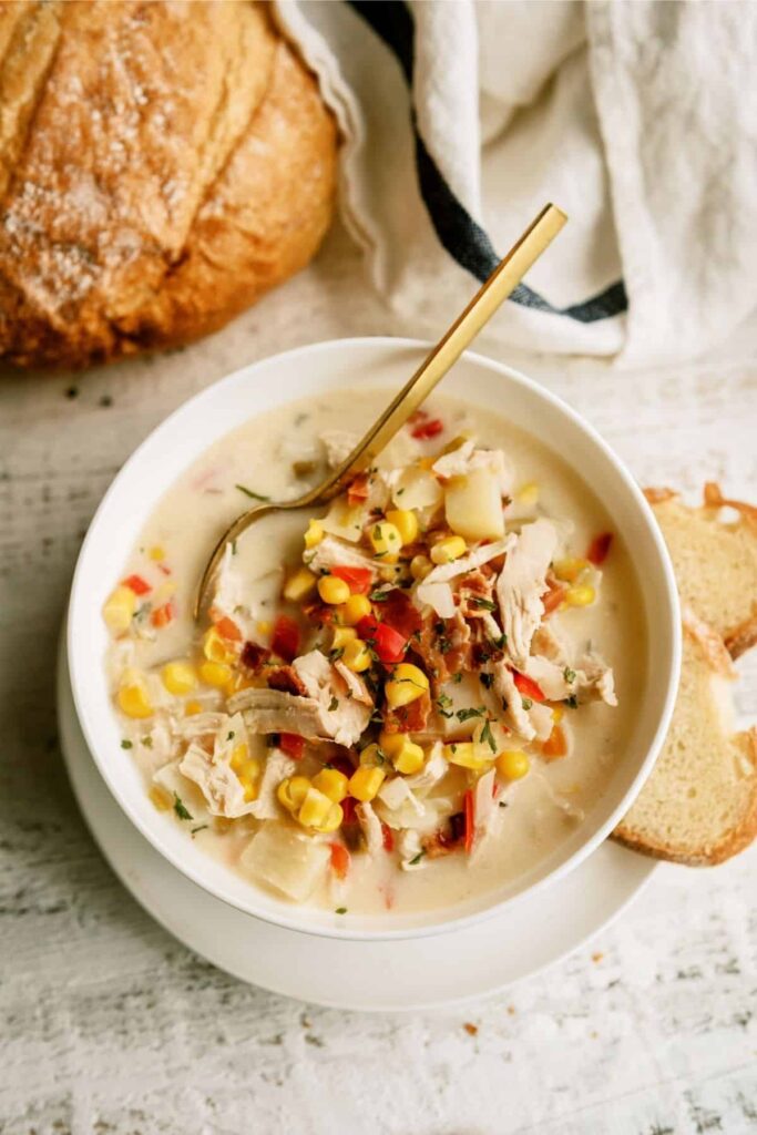 Hearty homemade chicken corn chowder with diced potatoes, carrots, and fresh herbs