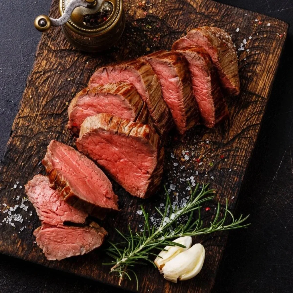 Medium-rare teres major steak slices served with chimichurri